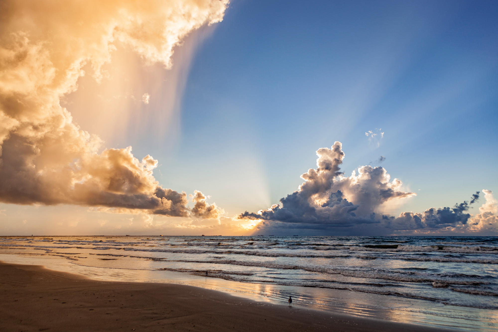 Blue sky and rain cloud at sunrise on the beach