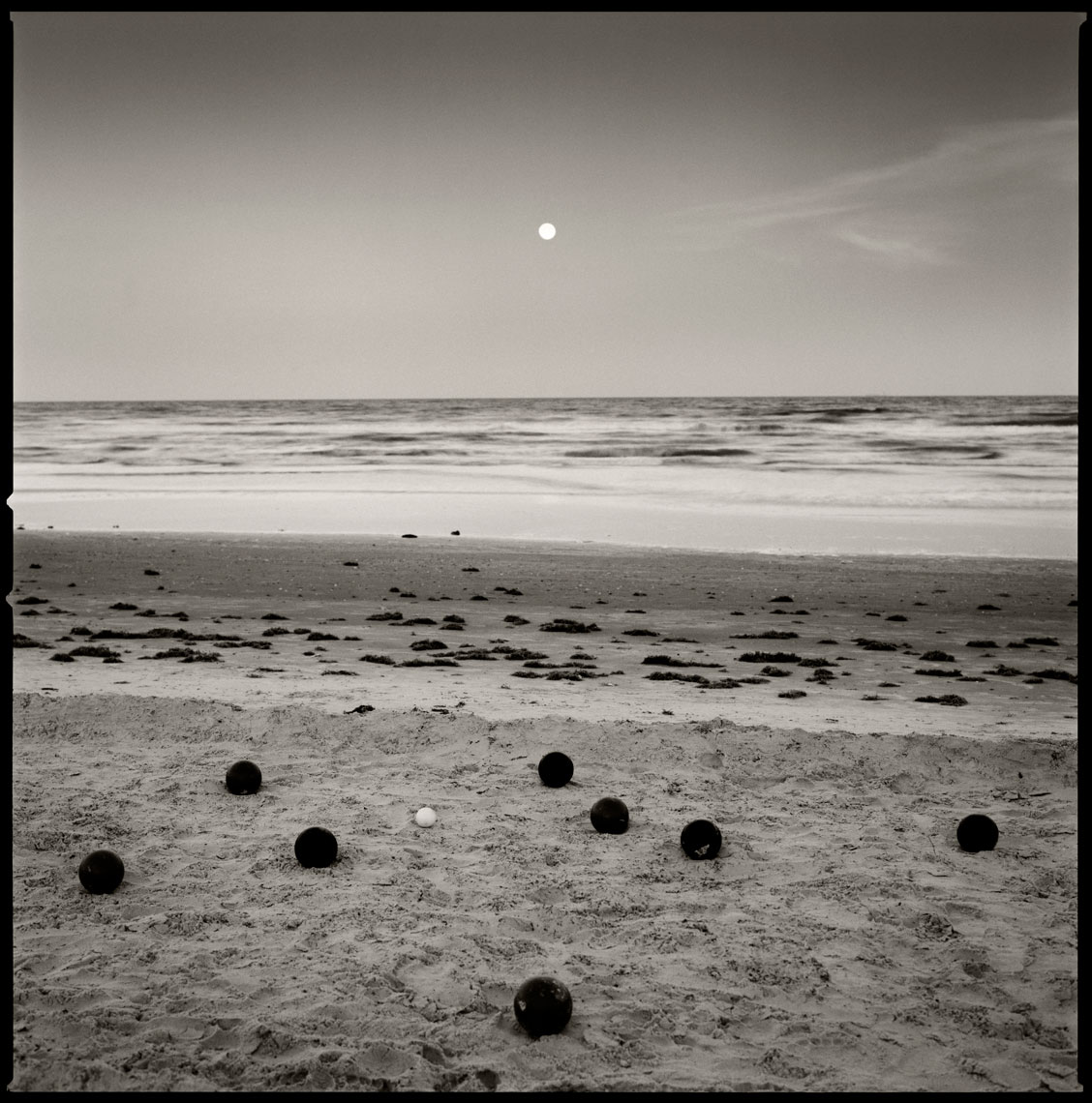 Bocce Balls on the beach with moon rise